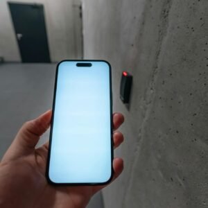 A smartphone unlocking a secure door using NFC technology in a modern building stairwell.
