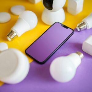 Colorful flat lay of smart home devices and smartphone on vibrant background, ideal for technology concepts.